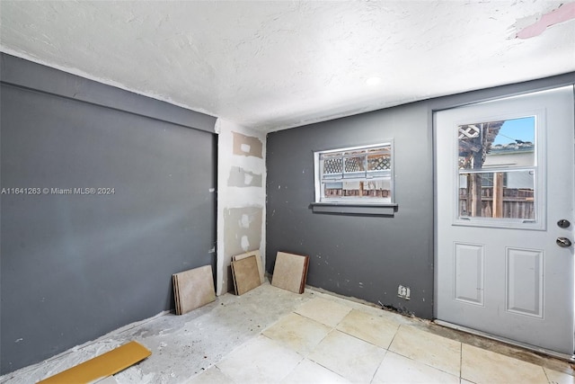 interior space with a textured ceiling