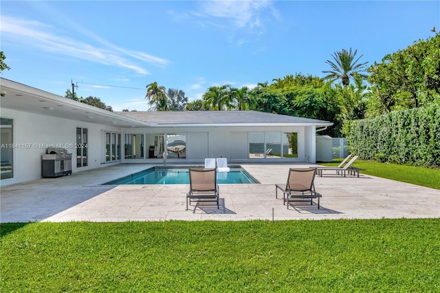 view of swimming pool featuring a yard and a patio