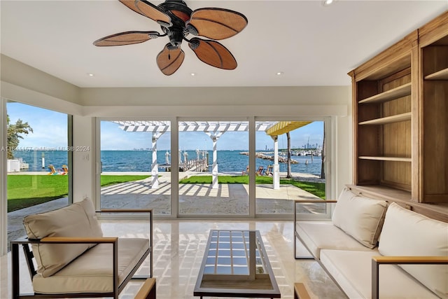 sunroom / solarium featuring a water view and a healthy amount of sunlight