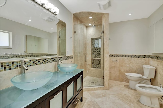 bathroom with an enclosed shower, vanity, a bidet, tile walls, and toilet