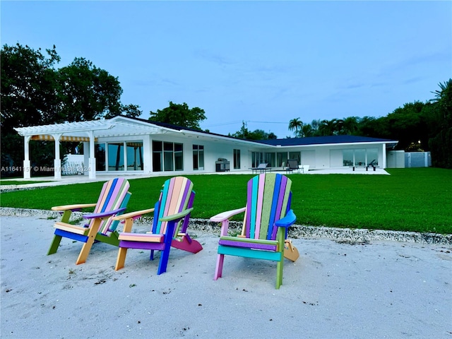 view of playground featuring a yard and a pergola