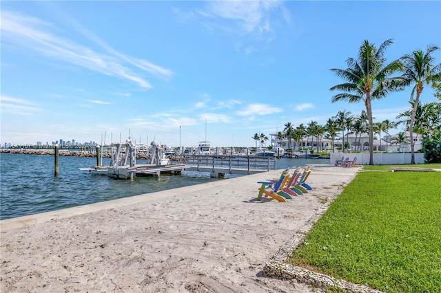 view of dock featuring a water view and a lawn