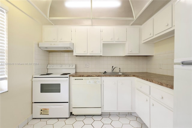 kitchen with tasteful backsplash, white appliances, white cabinetry, and light tile patterned floors