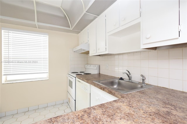 kitchen with white appliances, light tile patterned floors, premium range hood, sink, and tasteful backsplash