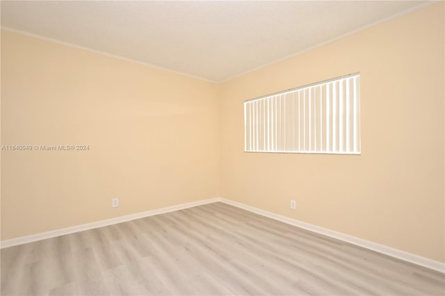 spare room featuring wood-type flooring