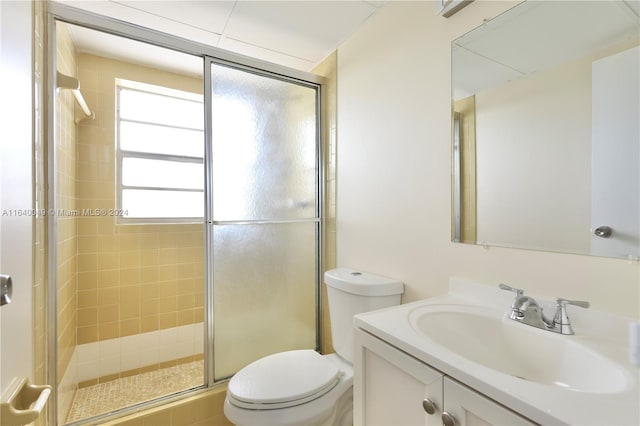 bathroom featuring an enclosed shower, vanity, and toilet