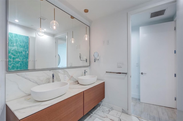 bathroom with double sink vanity, tile walls, and tile patterned floors