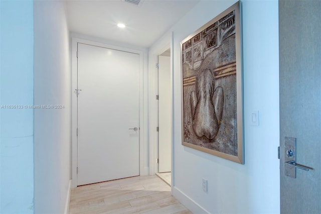 hallway with light hardwood / wood-style flooring