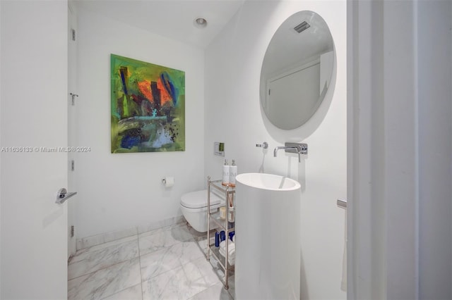 bathroom featuring sink, tile patterned flooring, and toilet