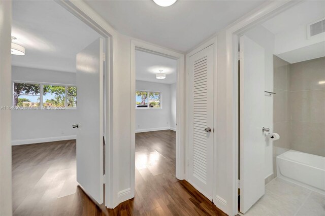 corridor with wood-type flooring