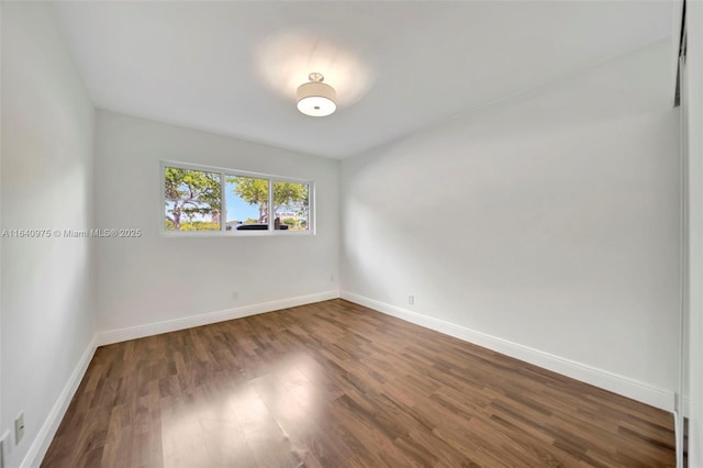 spare room featuring dark hardwood / wood-style floors