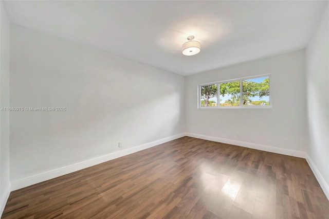 unfurnished room featuring dark hardwood / wood-style floors