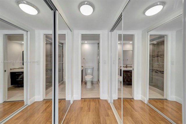 bathroom with vanity, toilet, and wood-type flooring