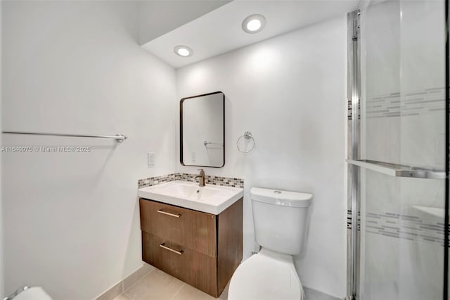 bathroom with walk in shower, tile patterned flooring, toilet, decorative backsplash, and vanity