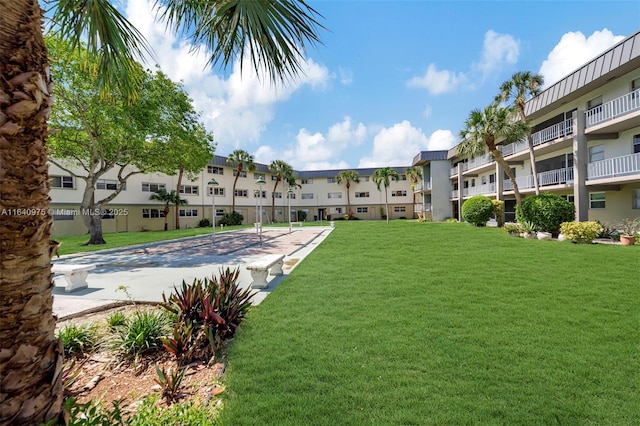 view of pool featuring a lawn