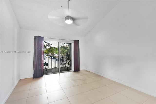 tiled empty room with lofted ceiling and ceiling fan