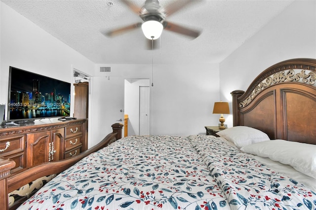 bedroom featuring a textured ceiling and ceiling fan