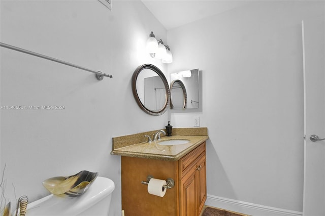 bathroom featuring vanity and toilet