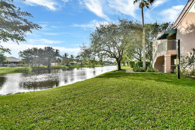 view of yard with a water view and a balcony