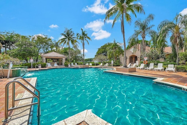 view of pool featuring a gazebo, pool water feature, and a patio area