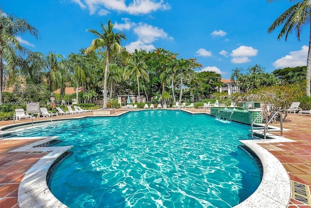 view of swimming pool with a patio and pool water feature