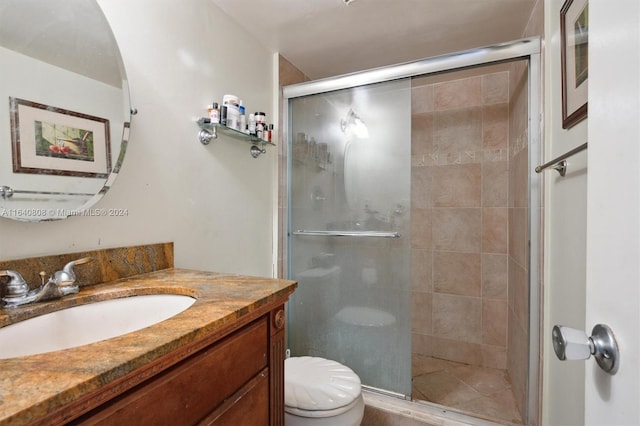 bathroom featuring toilet, vanity, and walk in shower