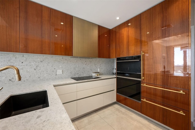 kitchen with black appliances, backsplash, modern cabinets, and a sink