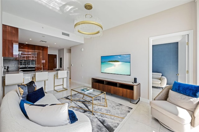 living area with visible vents, baseboards, and light tile patterned floors