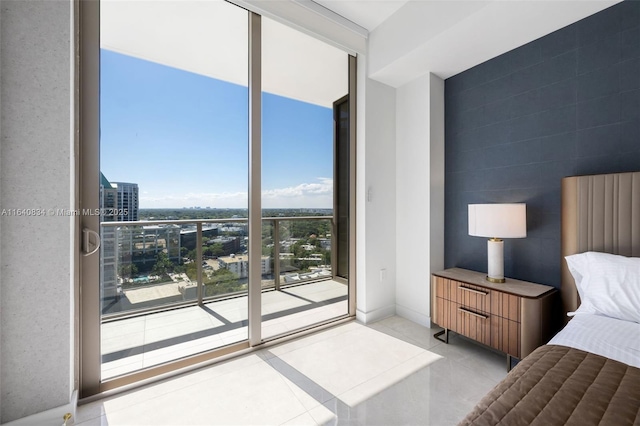 bedroom with access to exterior, tile patterned flooring, and floor to ceiling windows