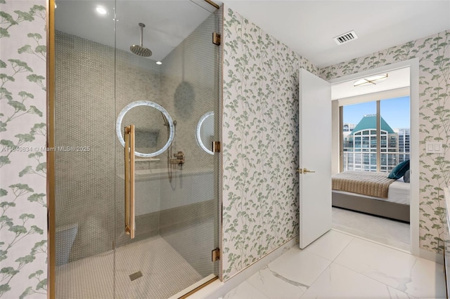 ensuite bathroom featuring ensuite bathroom, marble finish floor, a shower stall, and visible vents