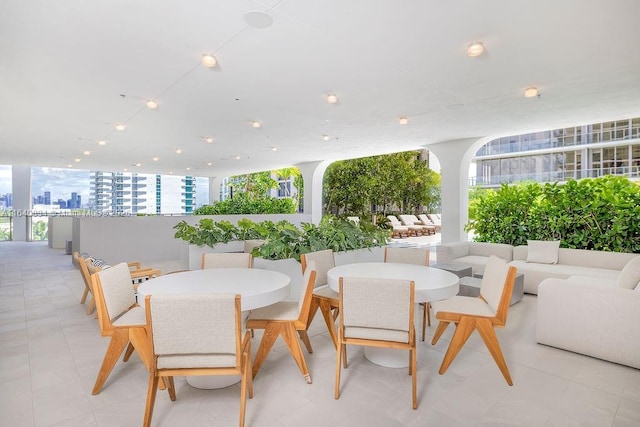 view of patio / terrace with outdoor dining area and a city view