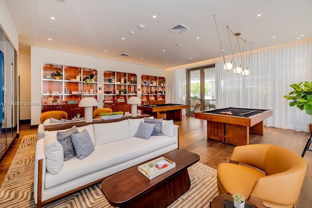 living area with recessed lighting, pool table, wood finished floors, visible vents, and french doors