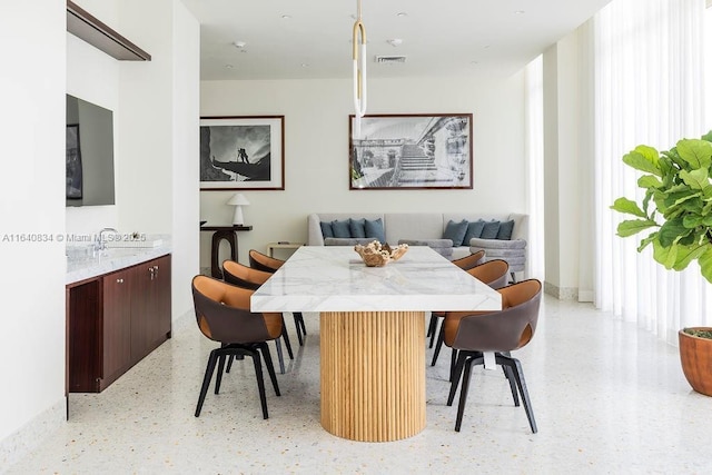 dining room with breakfast area, visible vents, and light speckled floor