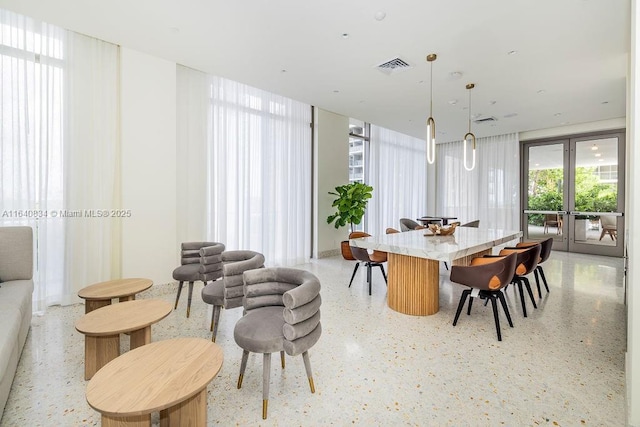 dining area featuring light speckled floor, french doors, and visible vents