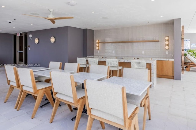 dining room with light floors, ceiling fan, and recessed lighting