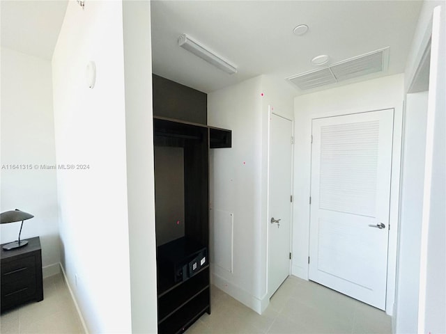 tiled bedroom with a closet