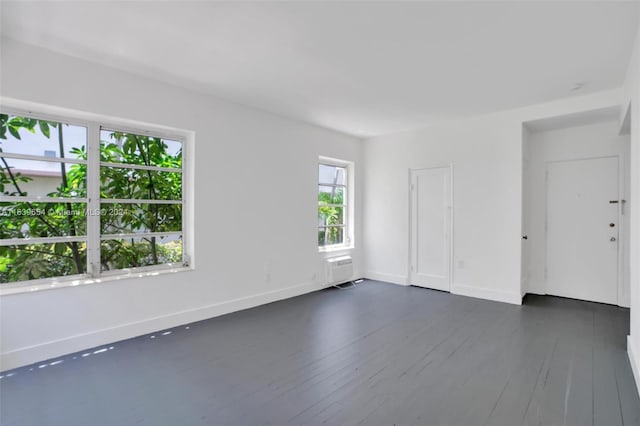 spare room featuring dark hardwood / wood-style flooring