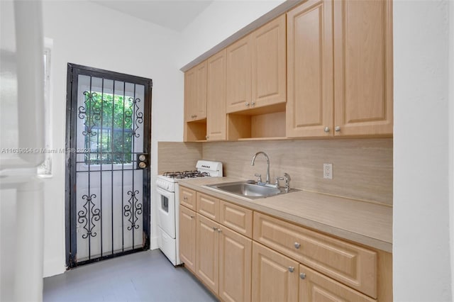 kitchen with backsplash, light brown cabinetry, light tile patterned floors, sink, and white gas range oven