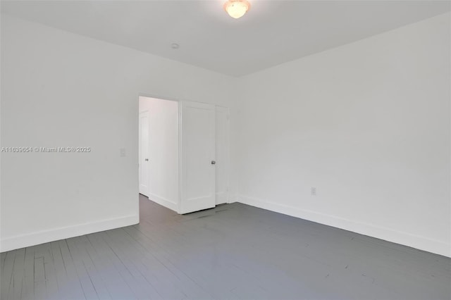 unfurnished room with dark hardwood / wood-style floors