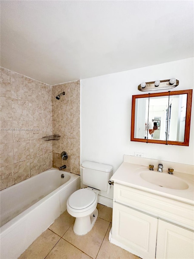 full bathroom with tile patterned floors, vanity, tiled shower / bath combo, and toilet