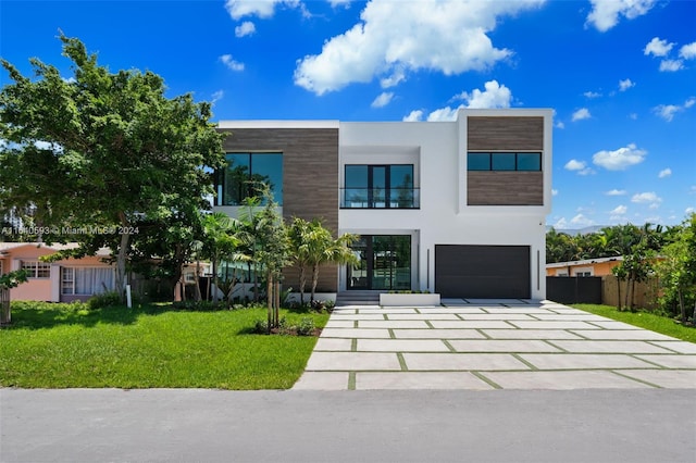 modern home featuring a front lawn and a garage