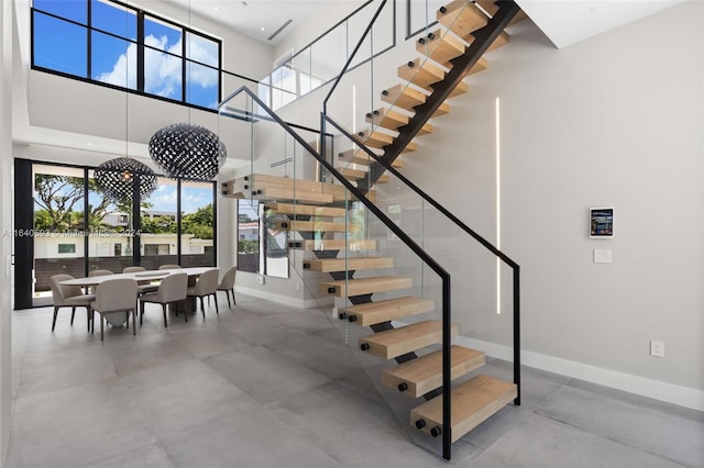 staircase featuring a high ceiling