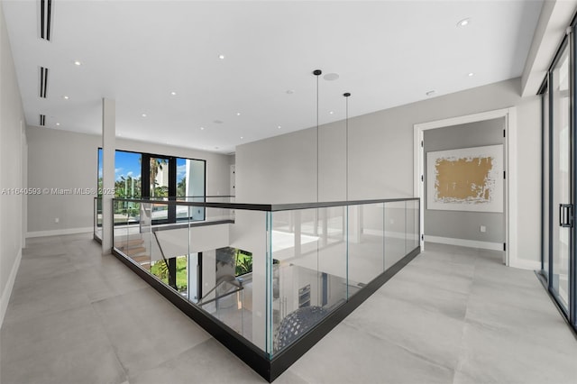 250 190th St, Sunny Isles Beach, FL 33160 - hallway featuring recessed lighting, concrete flooring, and an upstairs landing
