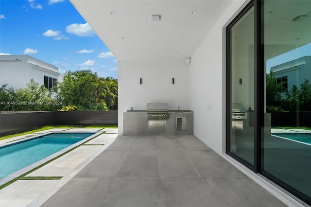 view of pool featuring area for grilling and a patio