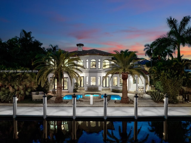 exterior space with a patio and a pool with hot tub