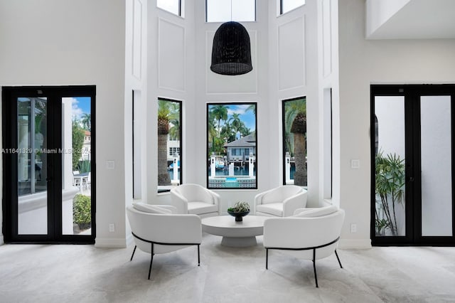 sitting room featuring a towering ceiling