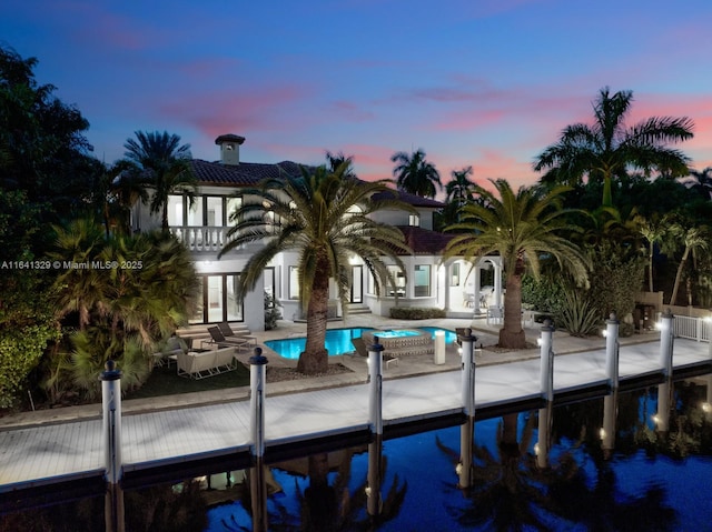 168 Fiesta Way, Fort Lauderdale, FL 33301 - back of house with a patio area, an outdoor pool, a balcony, french doors, and a tiled roof