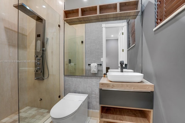 bathroom featuring vanity, toilet, tile walls, and walk in shower