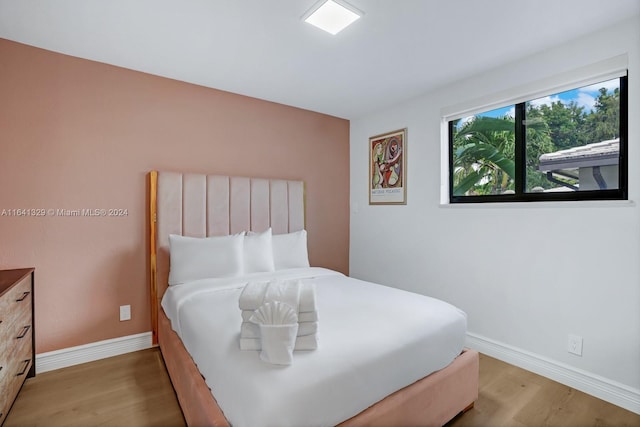 bedroom with wood-type flooring