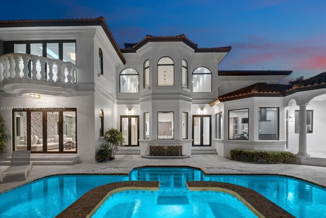 168 Fiesta Way, Fort Lauderdale, FL 33301 - rear view of house featuring a balcony, a tiled roof, french doors, and a patio area